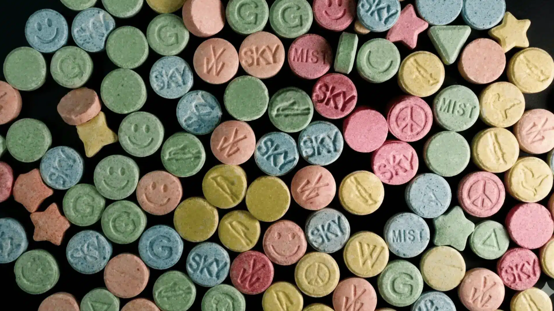 features a similar arrangement of colorful, patterned pills in