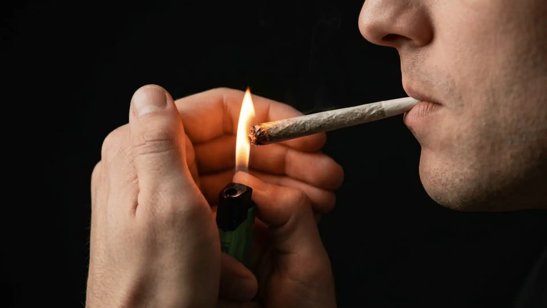 a high quality picture of joints smoking from a man in dark back ground