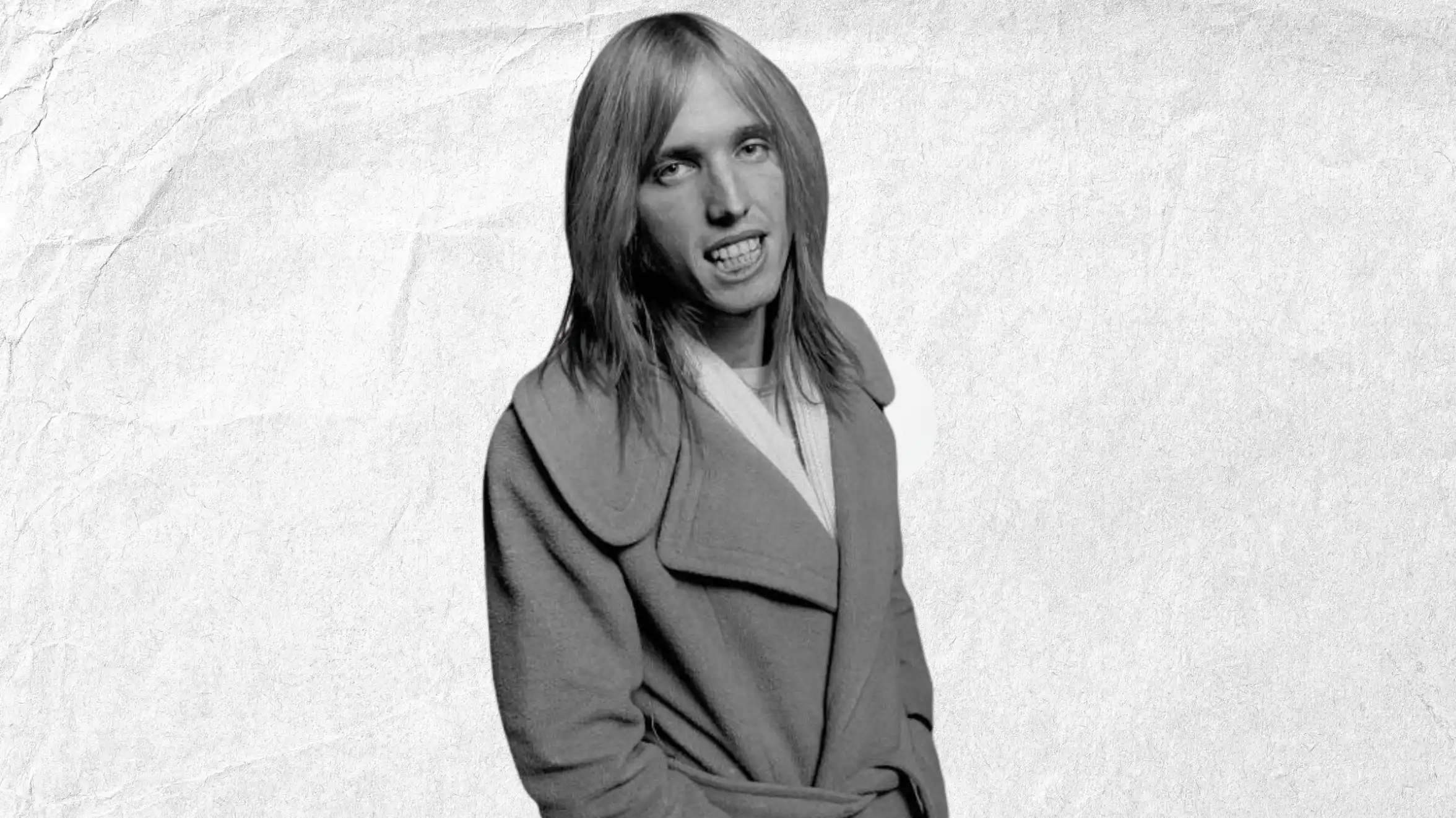 black and white portrait of long-haired person wearing coat, leaning forward, mouth open, against light background