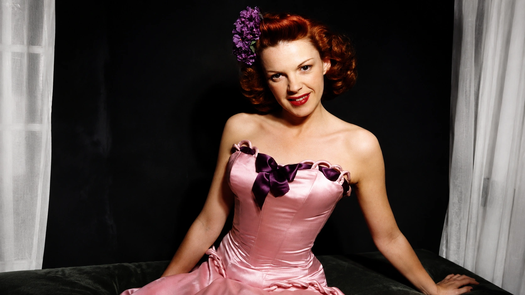 image for female singers who died of an overdose, showing a vintage-style woman in a pink dress posing elegantly