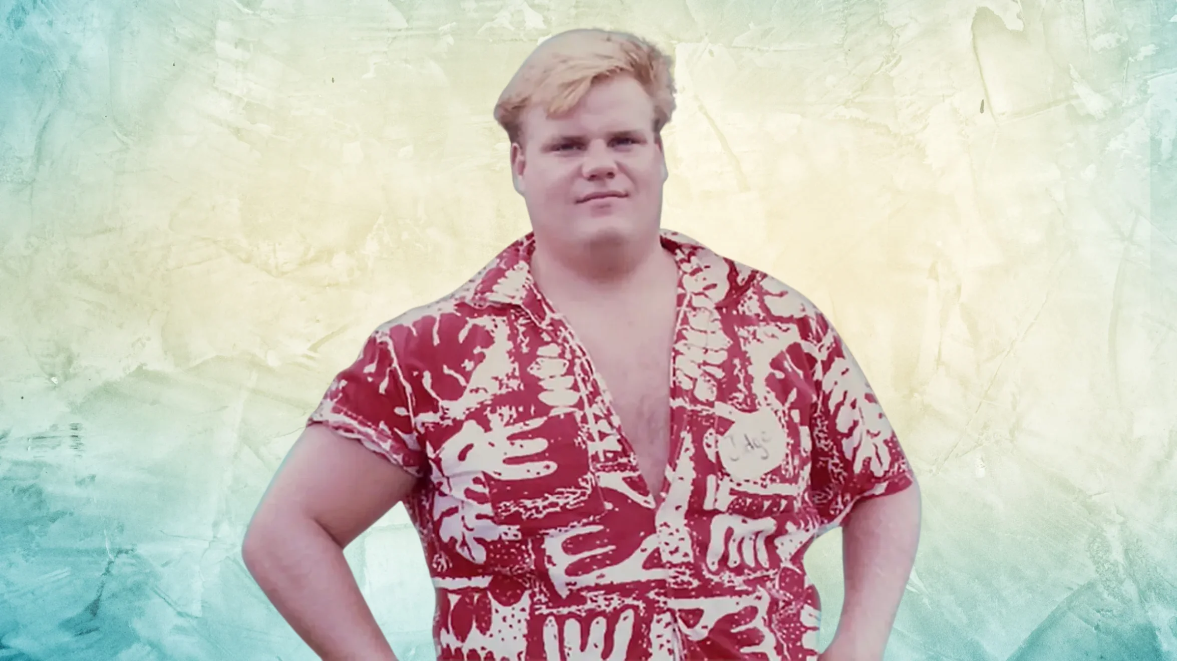 portrait of man with blond hair wearing red patterned shirt, standing with hands on hips against pastel background
