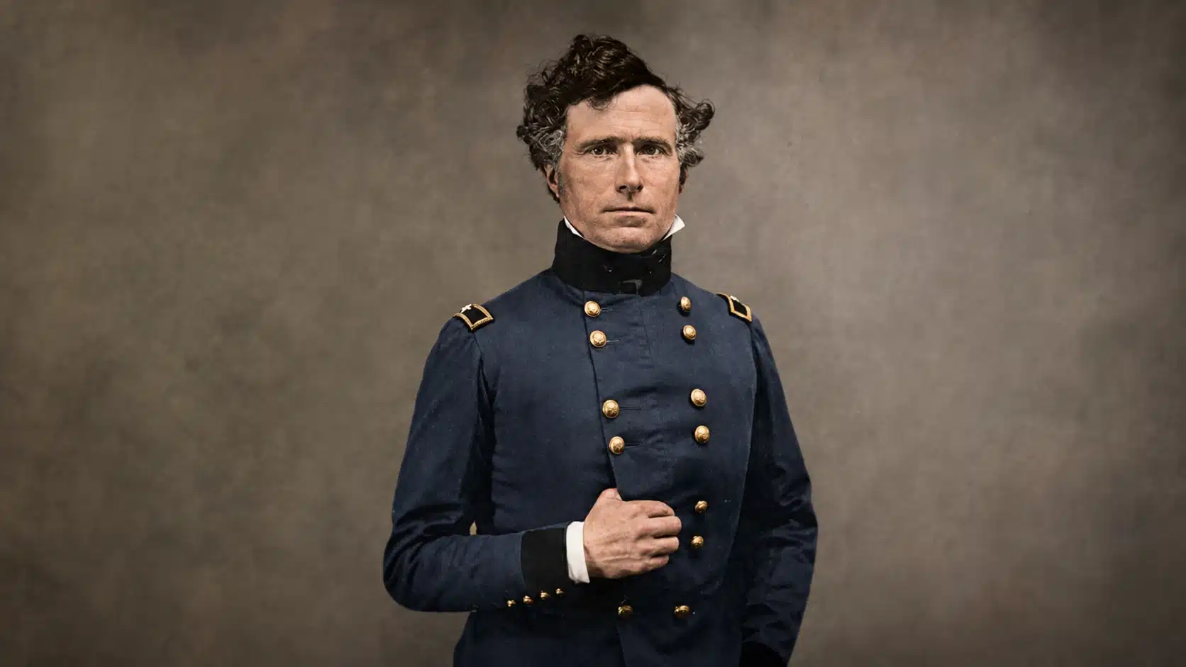 colorized portrait of a civil war officer in dark blue uniform with brass buttons against a textured gray backdrop
